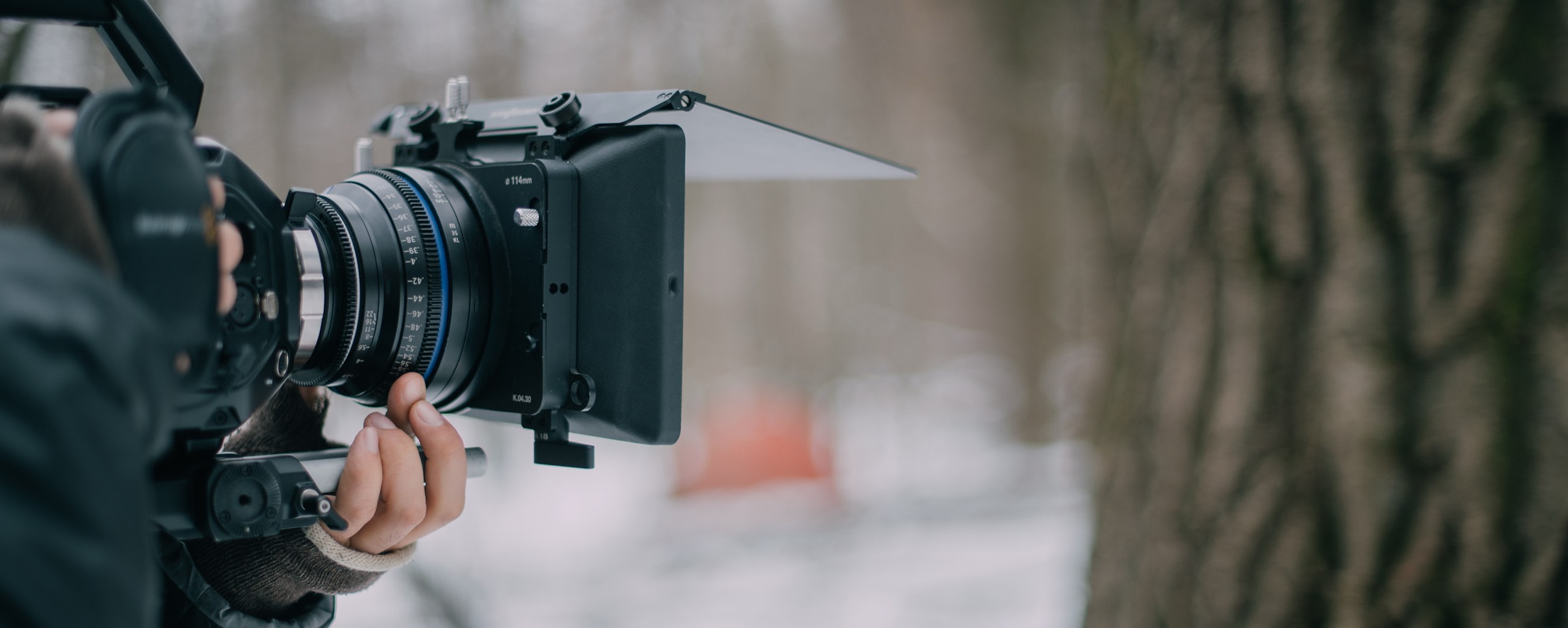 A cinema camera with a matte box, set up for a take